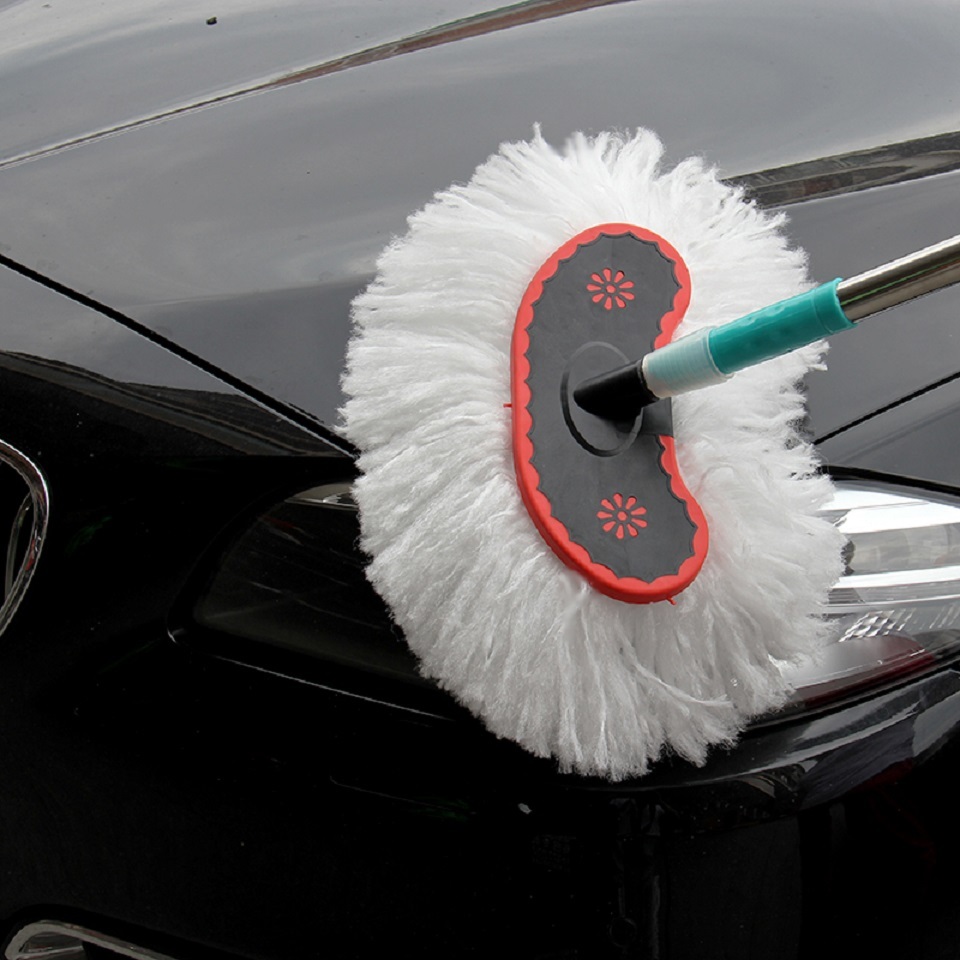 Woman washing car with a brush